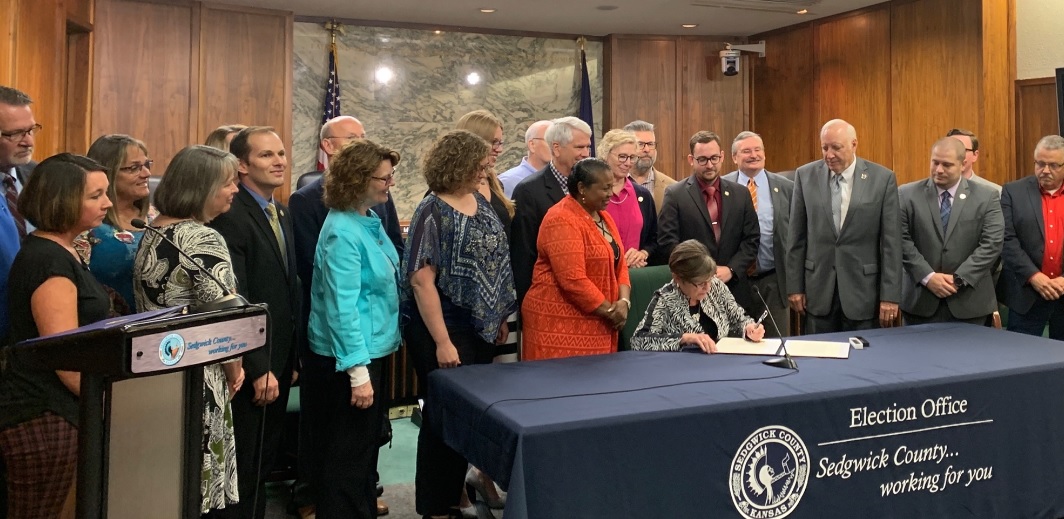 
Sen. Oletha Faust-Goudeau introduced a bill to enable Kansas voters to vote at any Kansas polling location, regardless of their address. Surrounded by Oletha's bipartisan co-sponsors, Gov. Kelly signs Oletha's bill into law -- fundamentally simplifying voting for everyone in Kansas. (CLICK to ENLARGE)
